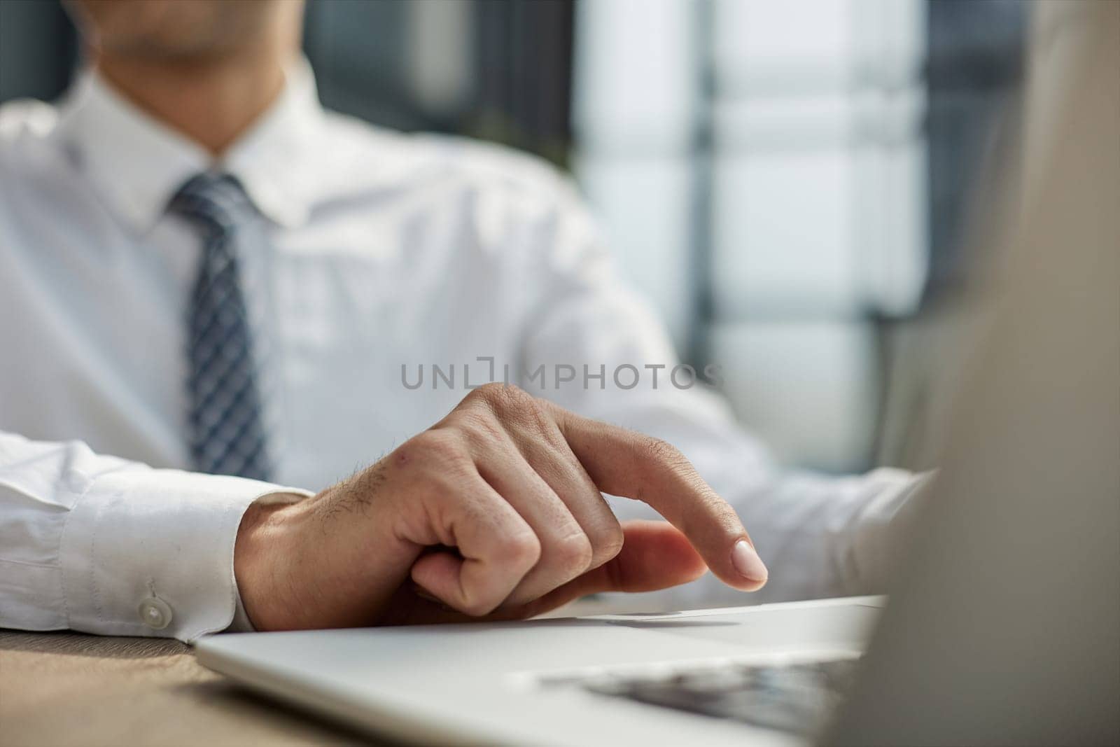 Close-up of a business person's hands on a laptop.