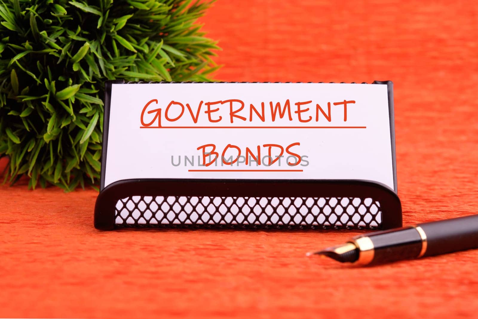 Government Bonds text on a white card on a stand on an orange background