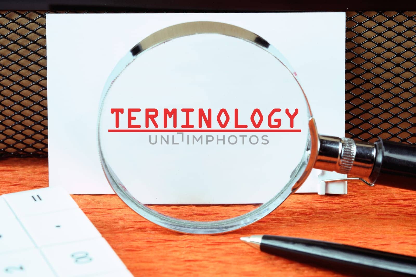 TERMINOLOGY text written on a white card through a magnifying glass
