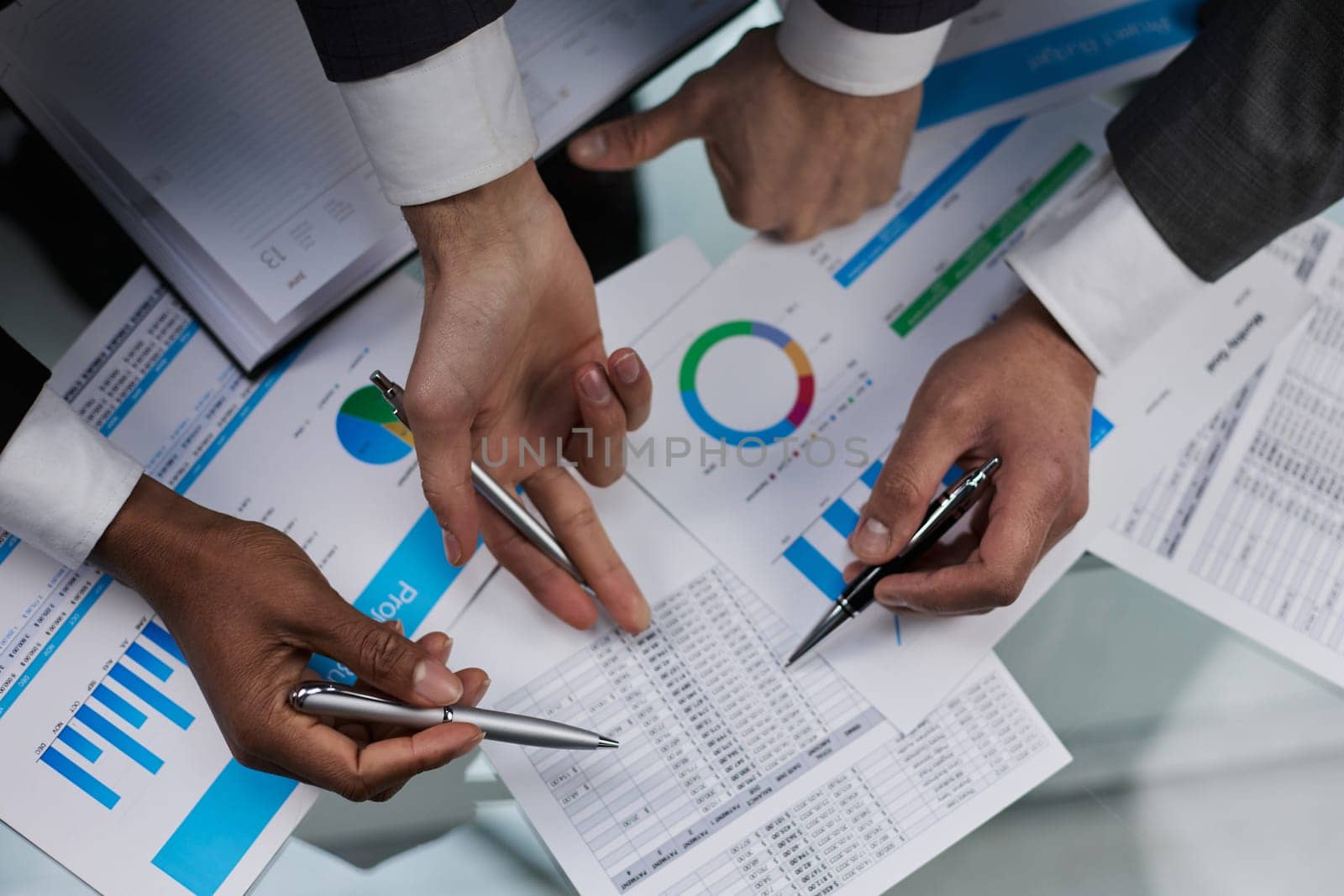 close-up. business colleagues look at the graph on the table from above