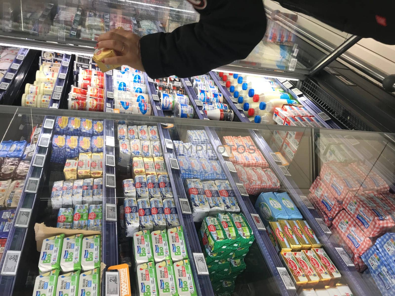 France, Bordeaux, February, 2, 2024: Woman choosing butter at supermarket, High quality photo
