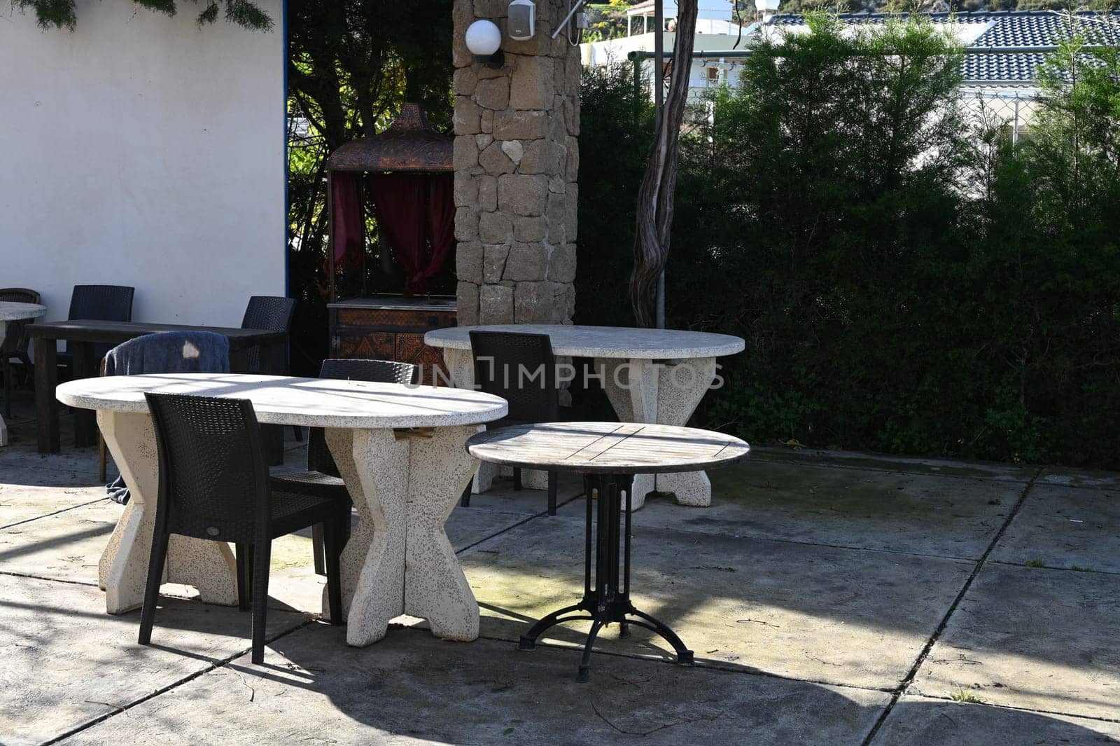 table and chairs in a restaurant in Cyprus in winter outdoors by Mixa74