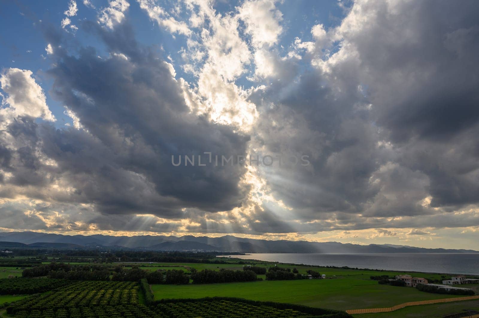 sun rays through dramatic clouds over mountains and sea in cyprus 3