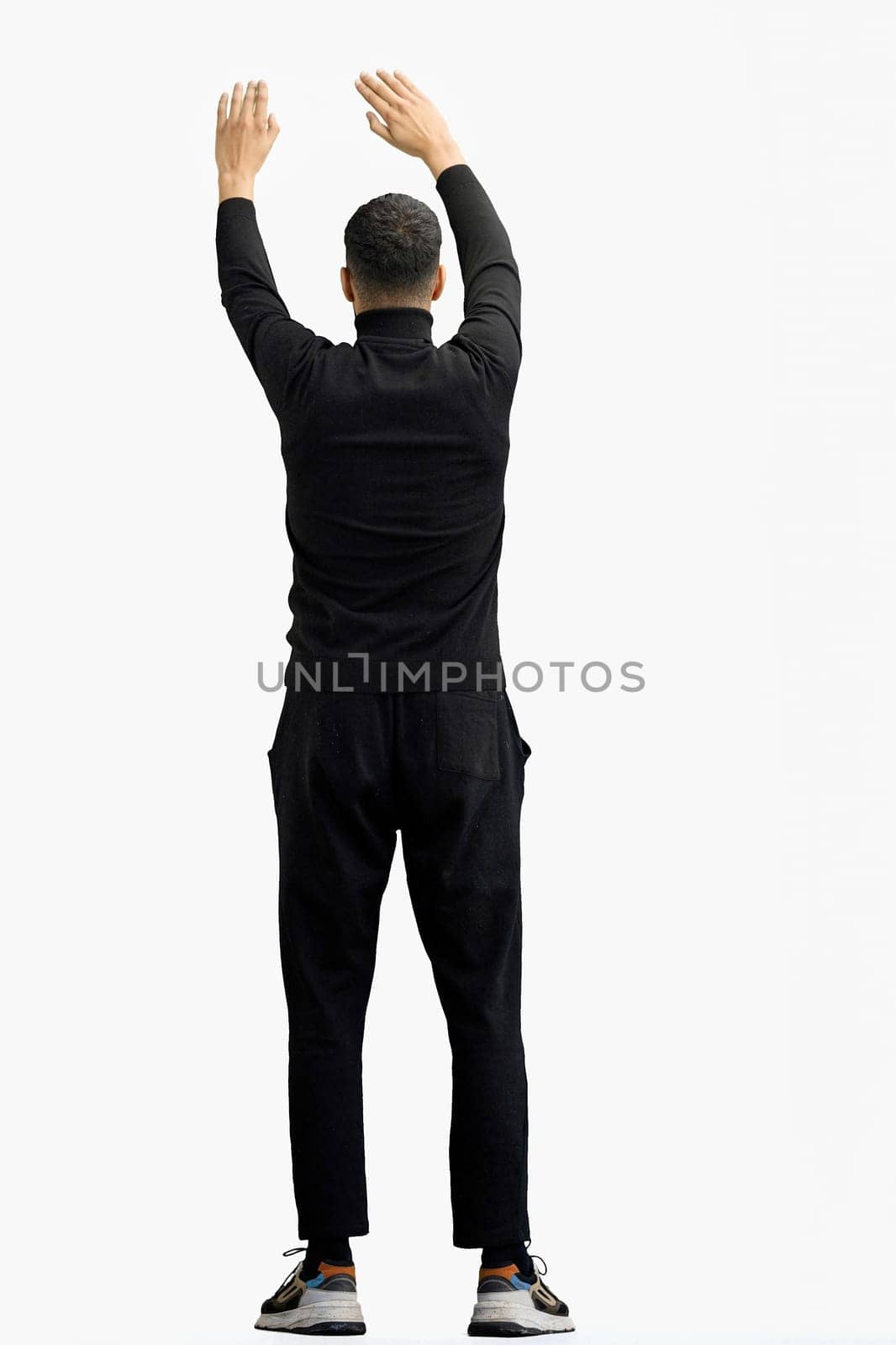 A man, full-length, on a white background, waving his arms.