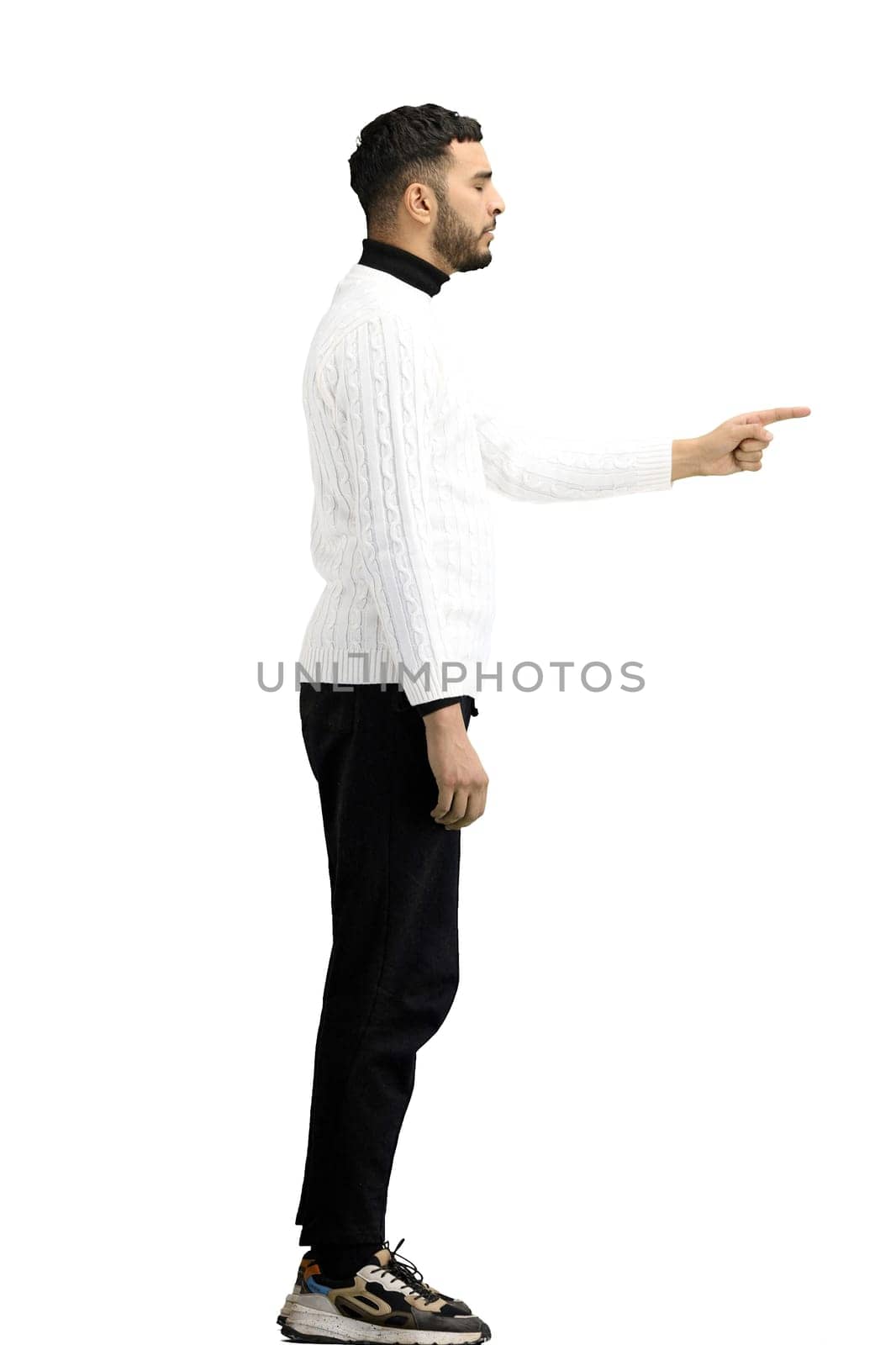 A man, full-length, on a white background, points to the side.