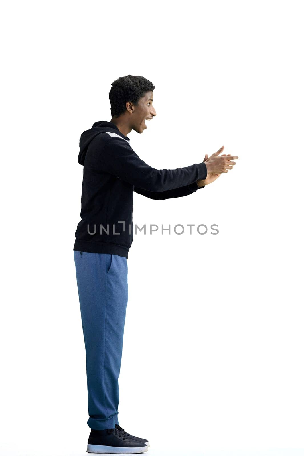 A man, full-length, on a white background, claps.