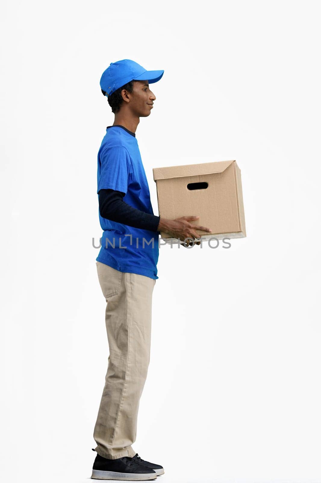 The deliveryman, full-length, on a white background, with a box.