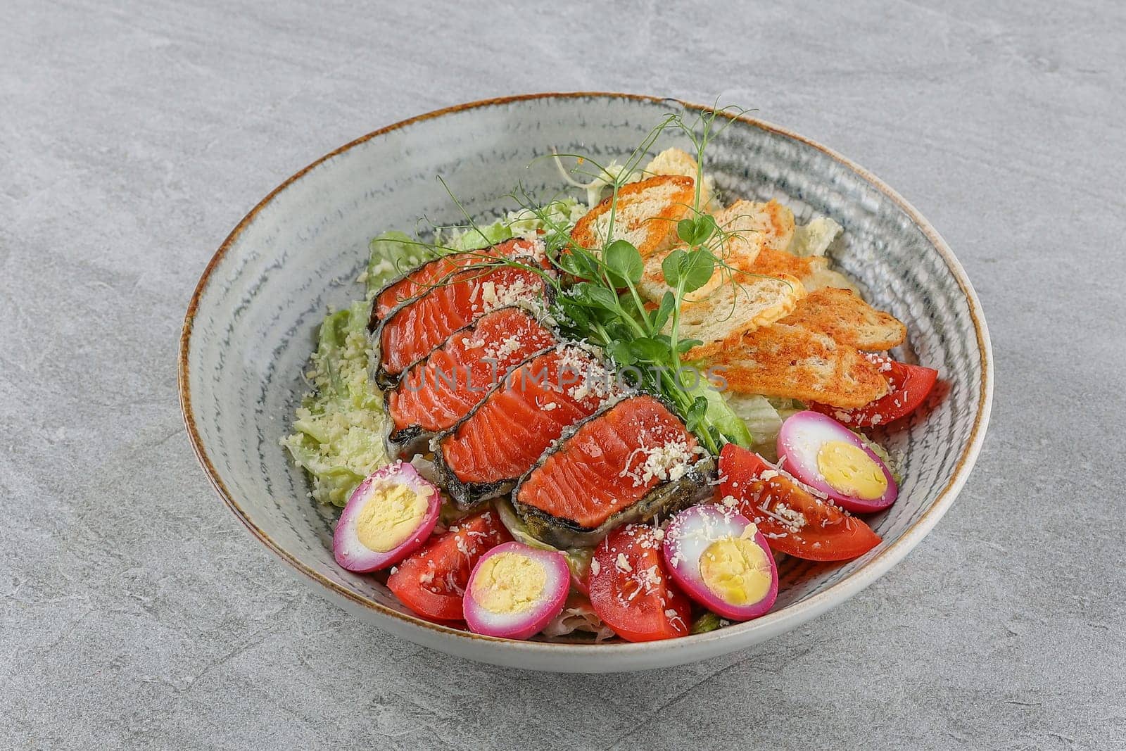 Salmon salad on a stone background studio shooting