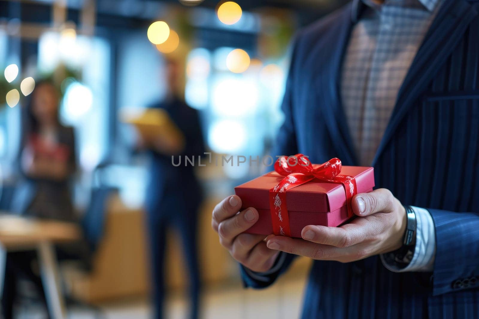 Photo of hands Giving a business gift in an office. Office holiday celebration.
