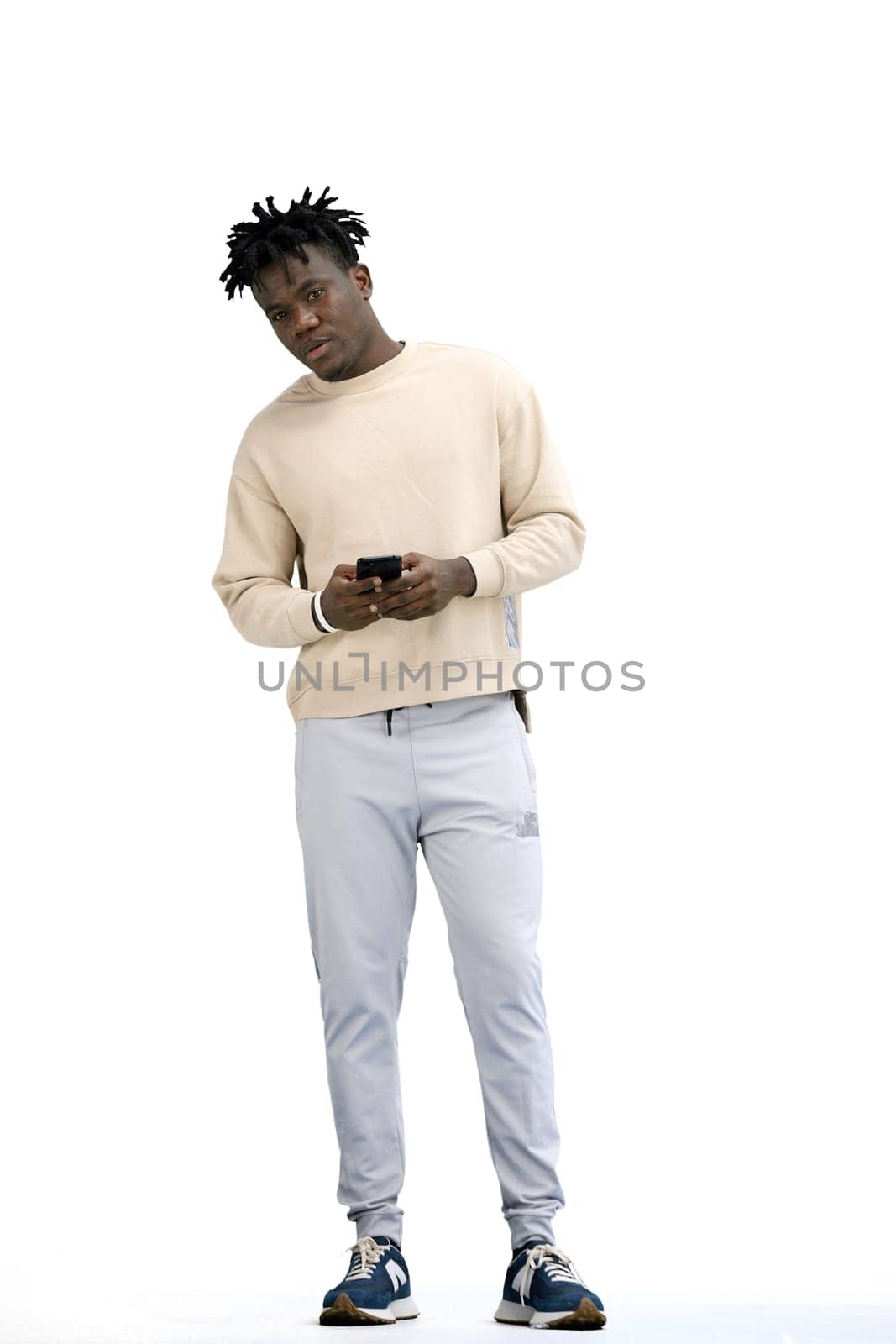 A man, full-length, on a white background, uses a phone by Prosto