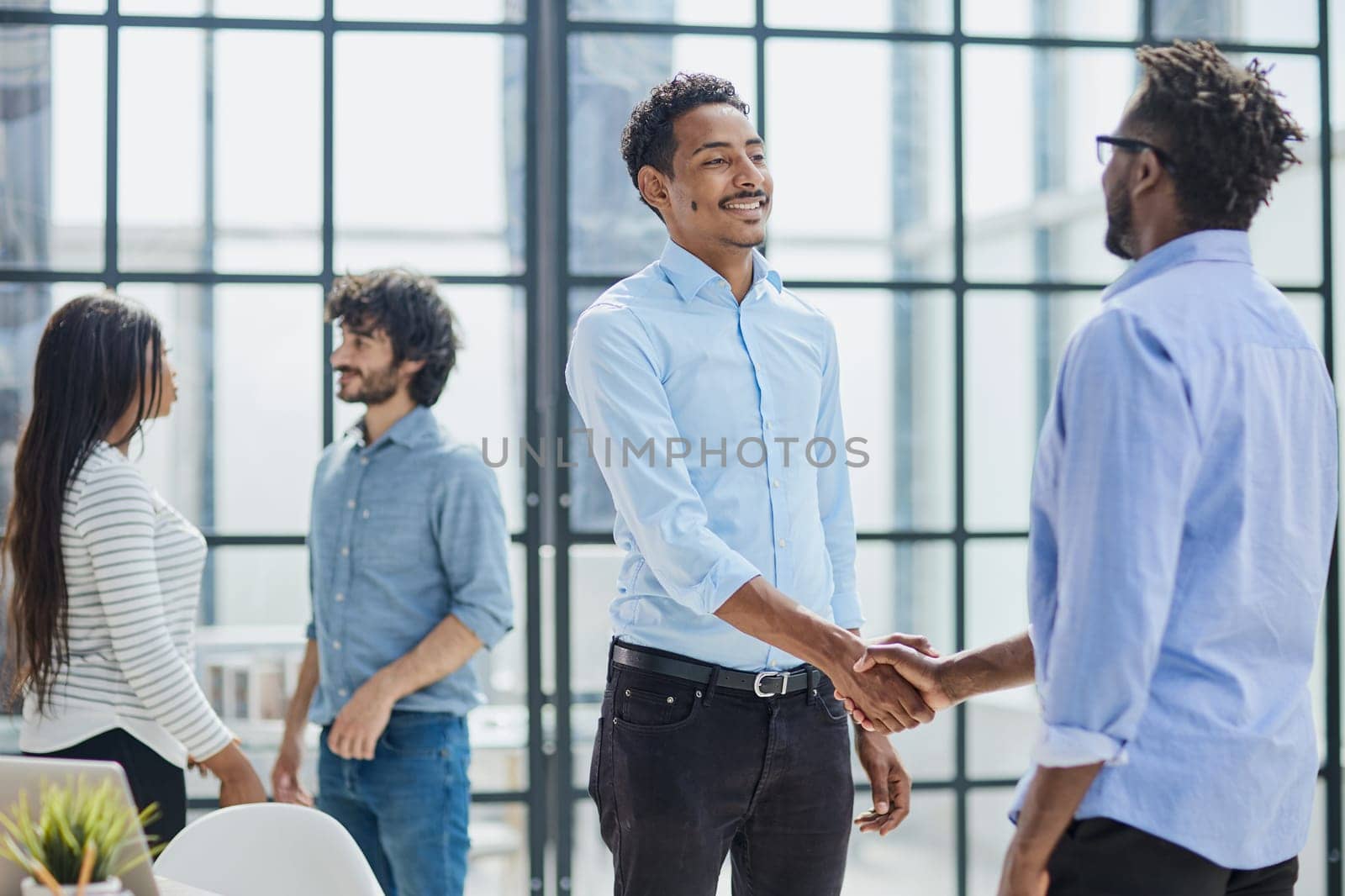 Successful Business Collaboration: Executives Greet with Handshake in Office by Prosto