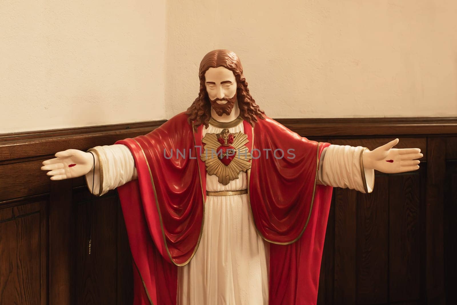 Statue of Jesus with a red heart white background