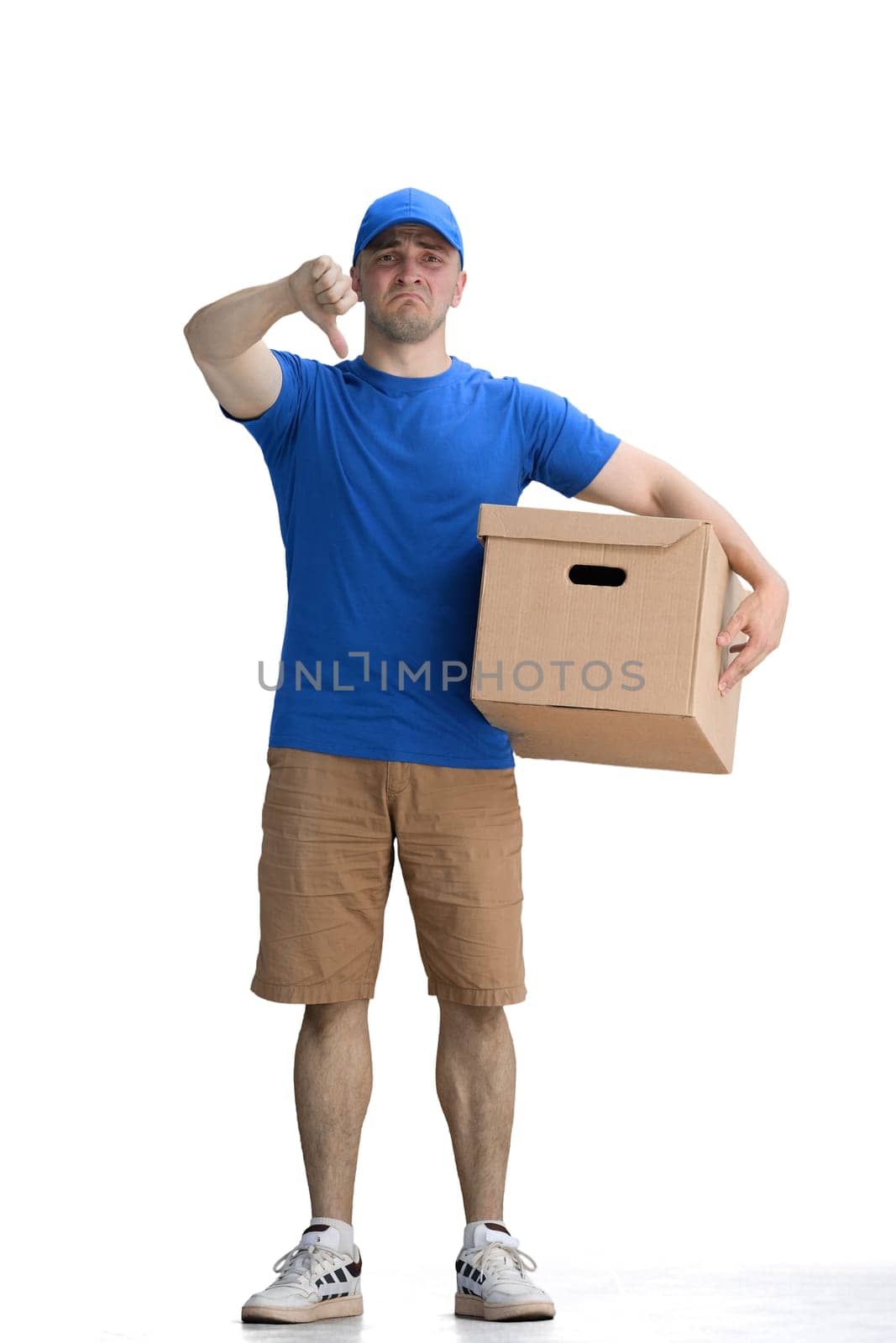 A male deliveryman, on a white background, full-length, with a box, shows his finger down by Prosto