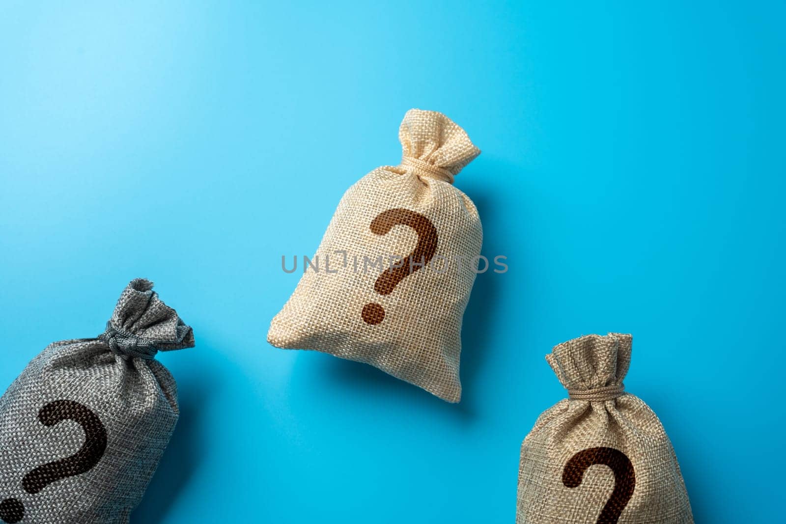 Bags with question marks. Inquiry, surprises or hidden secrets. Business and finance. Challenges and cases.