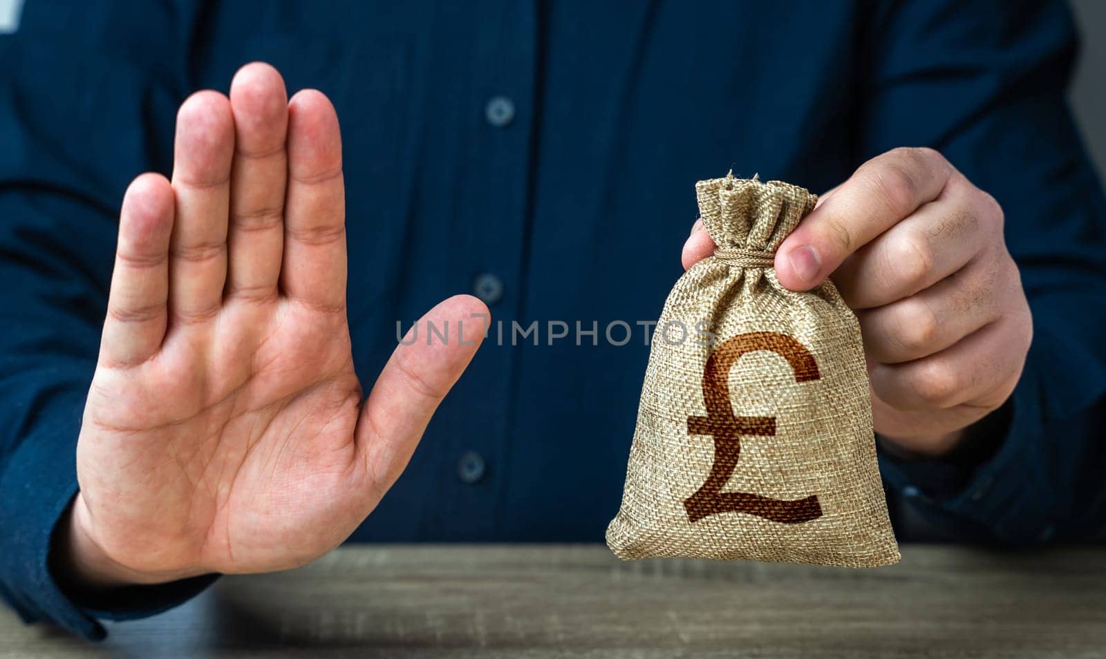Stop gesture and british pound sterling money bag. Financial difficulties. Asset freeze seizure. Economic sanctions, confiscation of funds. The man does not approve of the transaction or loan. by iLixe48