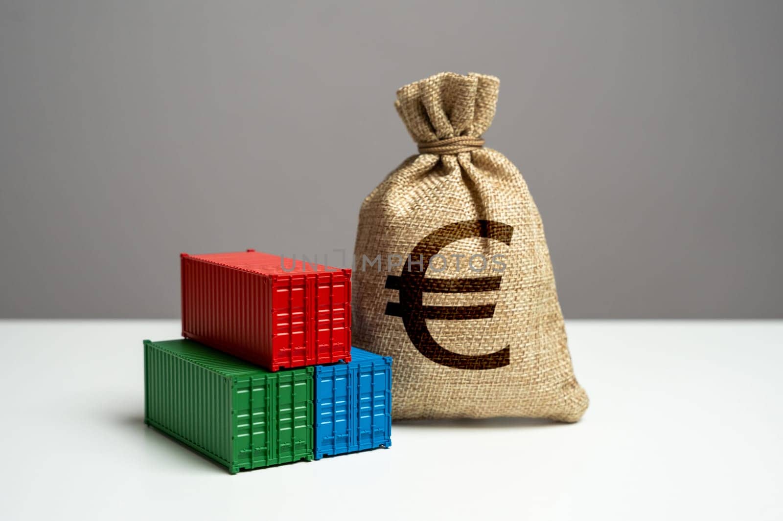 Stack of shipping containers and euro money bag. Trade, economics and transport industry. Tariffs and tax collections. Production of containers. GDP and production. Import or export.