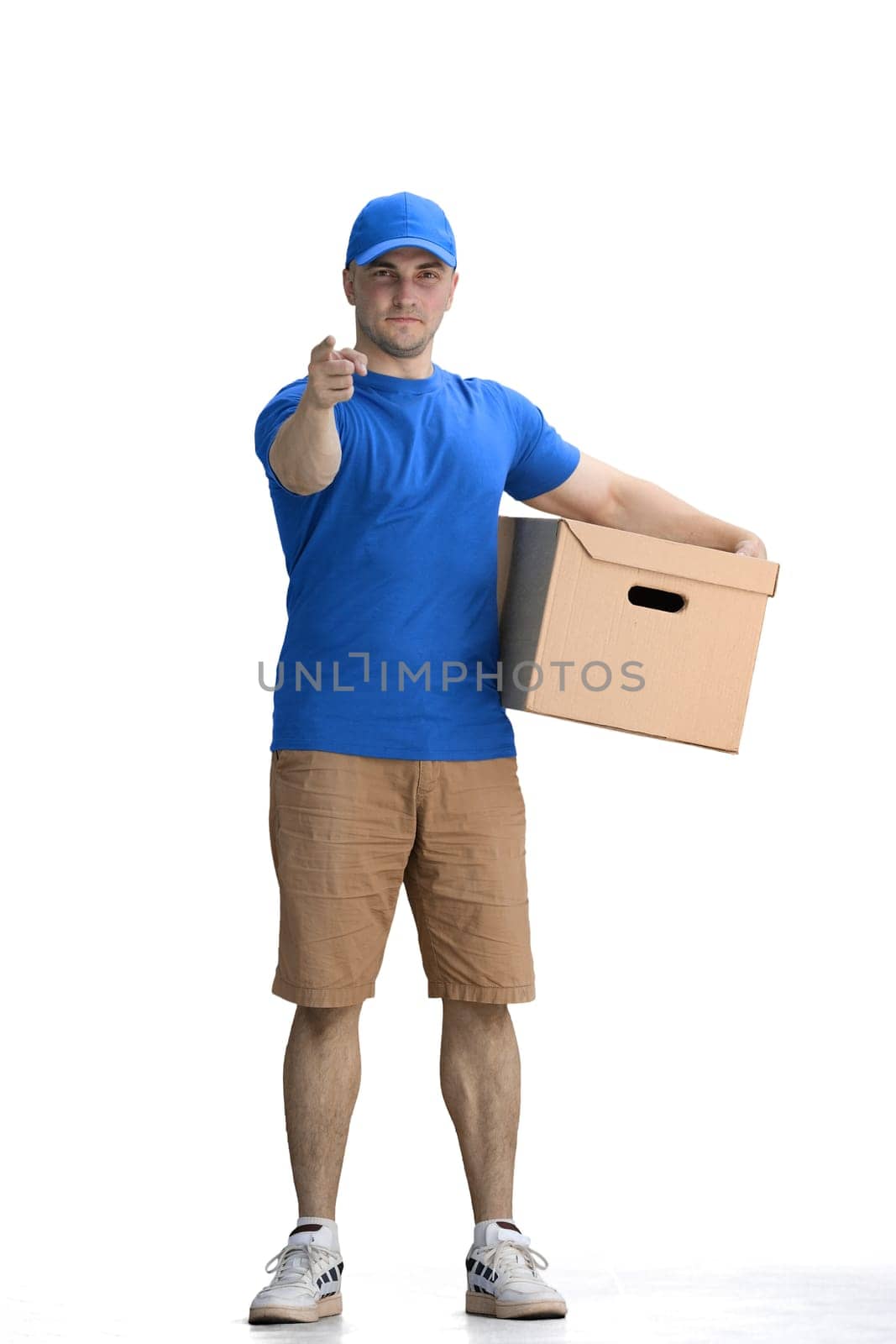 A male deliveryman, on a white background, full-length, with a box, points up by Prosto