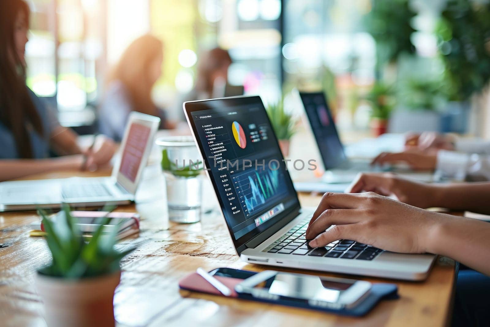 Person using a laptop with financial data with graphs and charts on a laptop computer at workplace.