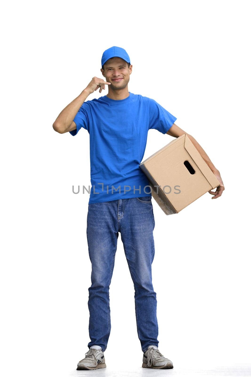 A male deliveryman, on a white background, in full height, with a box, shows a call sign by Prosto