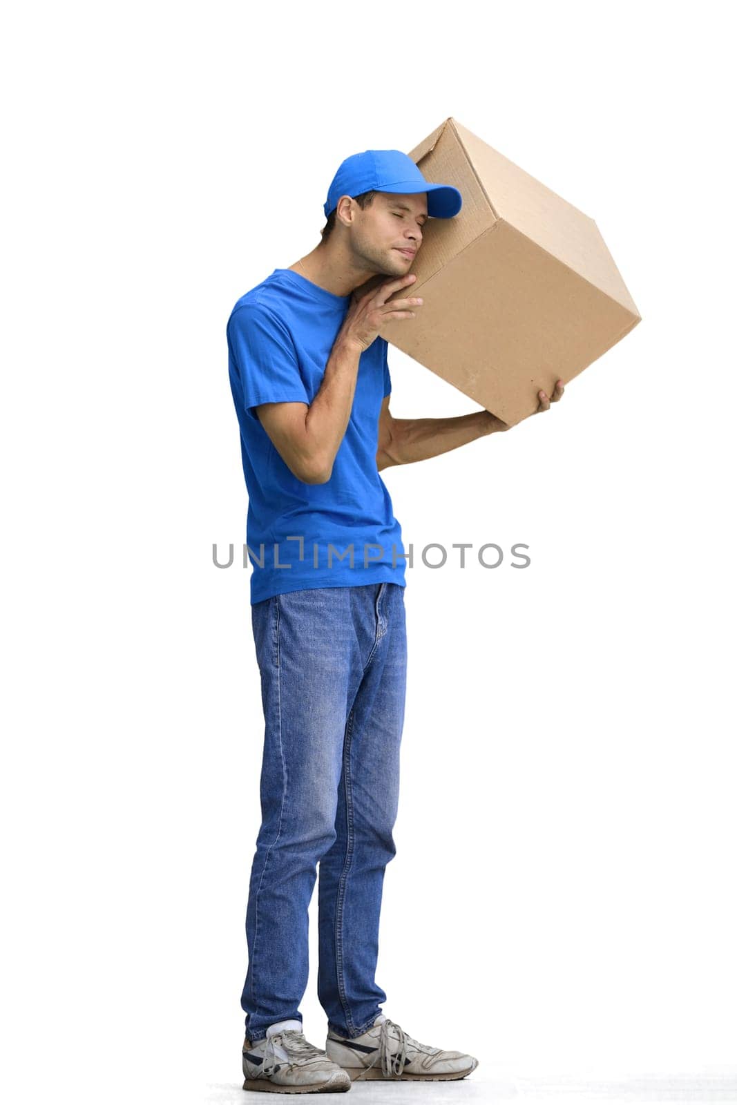A male deliveryman, on a white background, in full height, shakes a box by Prosto