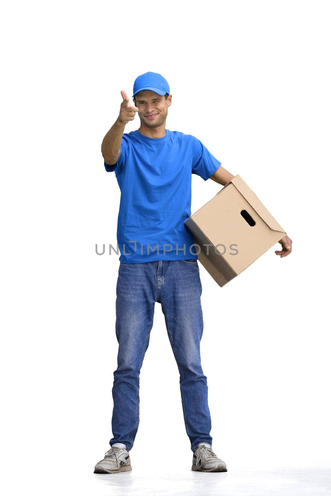 A male deliveryman, on a white background, full-length, with a box, points forward.