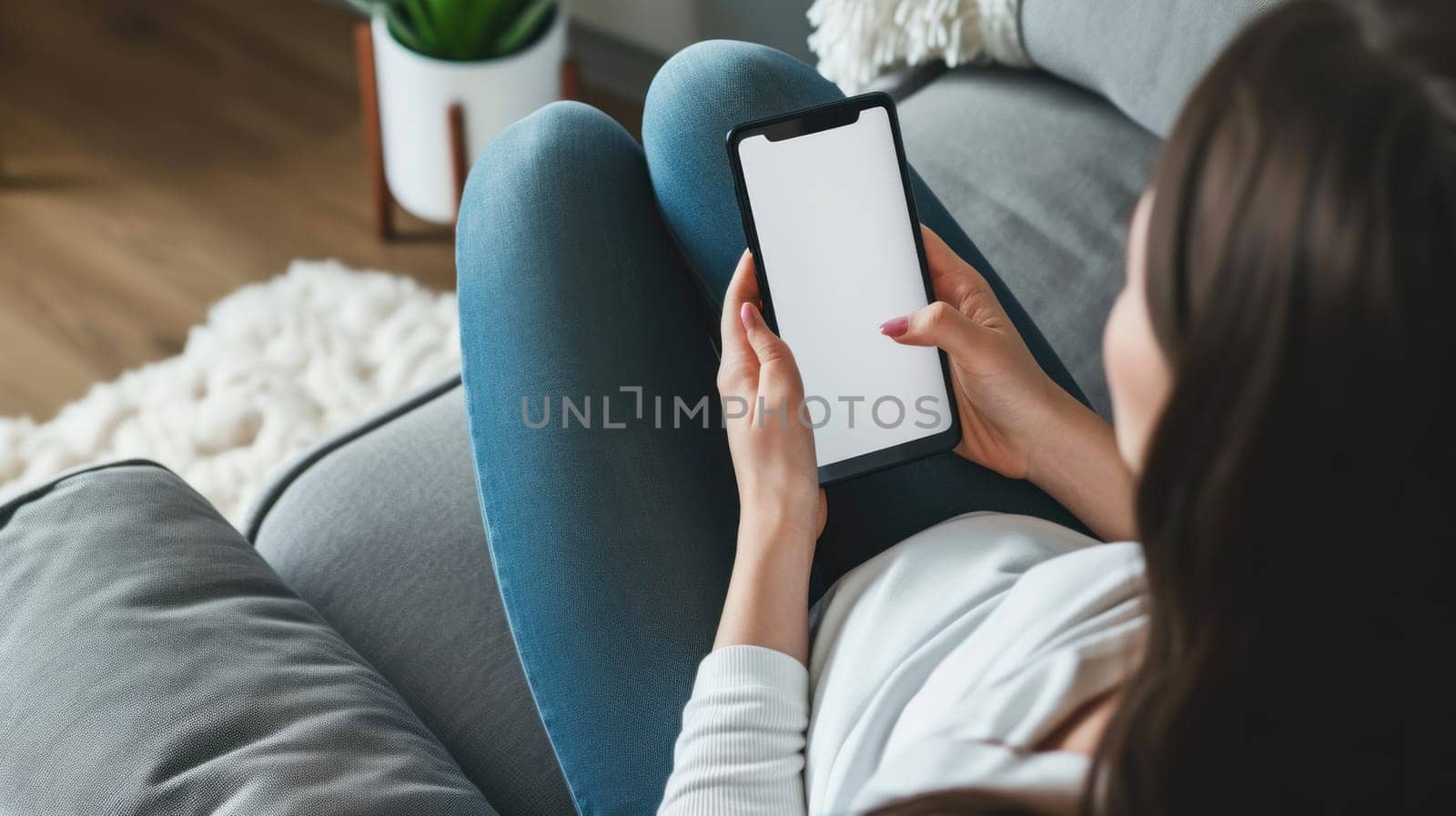 Woman on the couch using blank white screen smartphone. Generative AI by golfmerrymaker