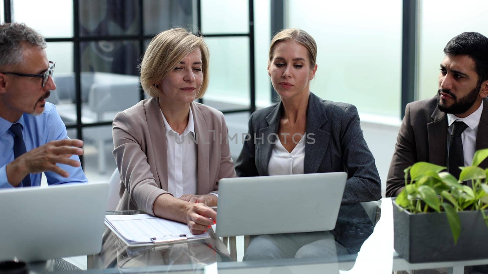 Portrait of creative business team using laptop in office