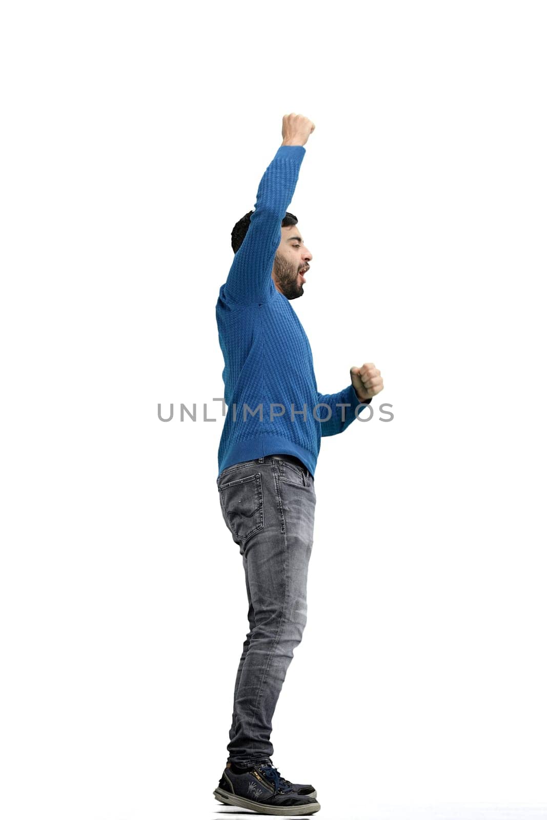 A man, full-length, on a white background, rejoices.