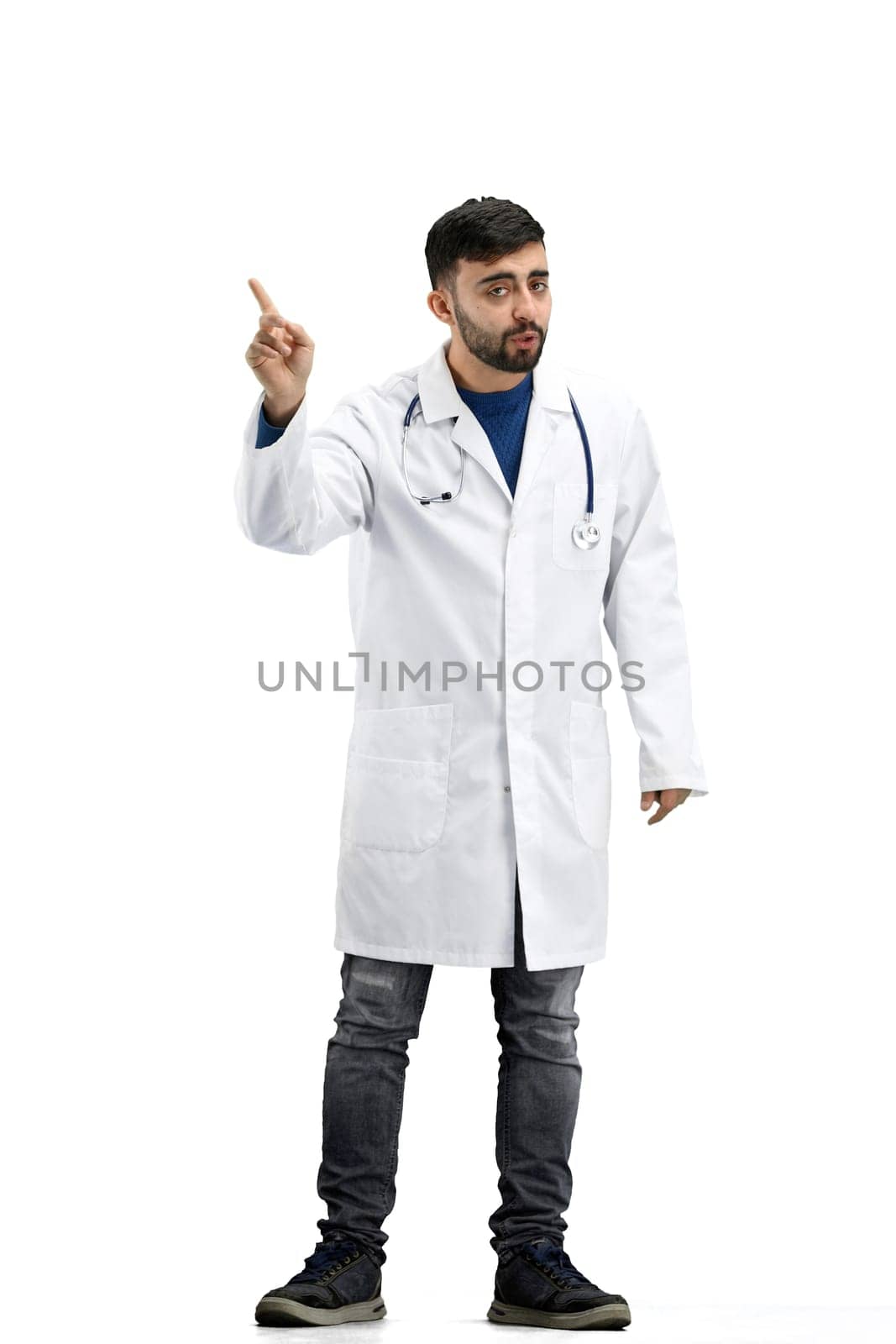 The doctor, in full height, on a white background, shows a stop sign.