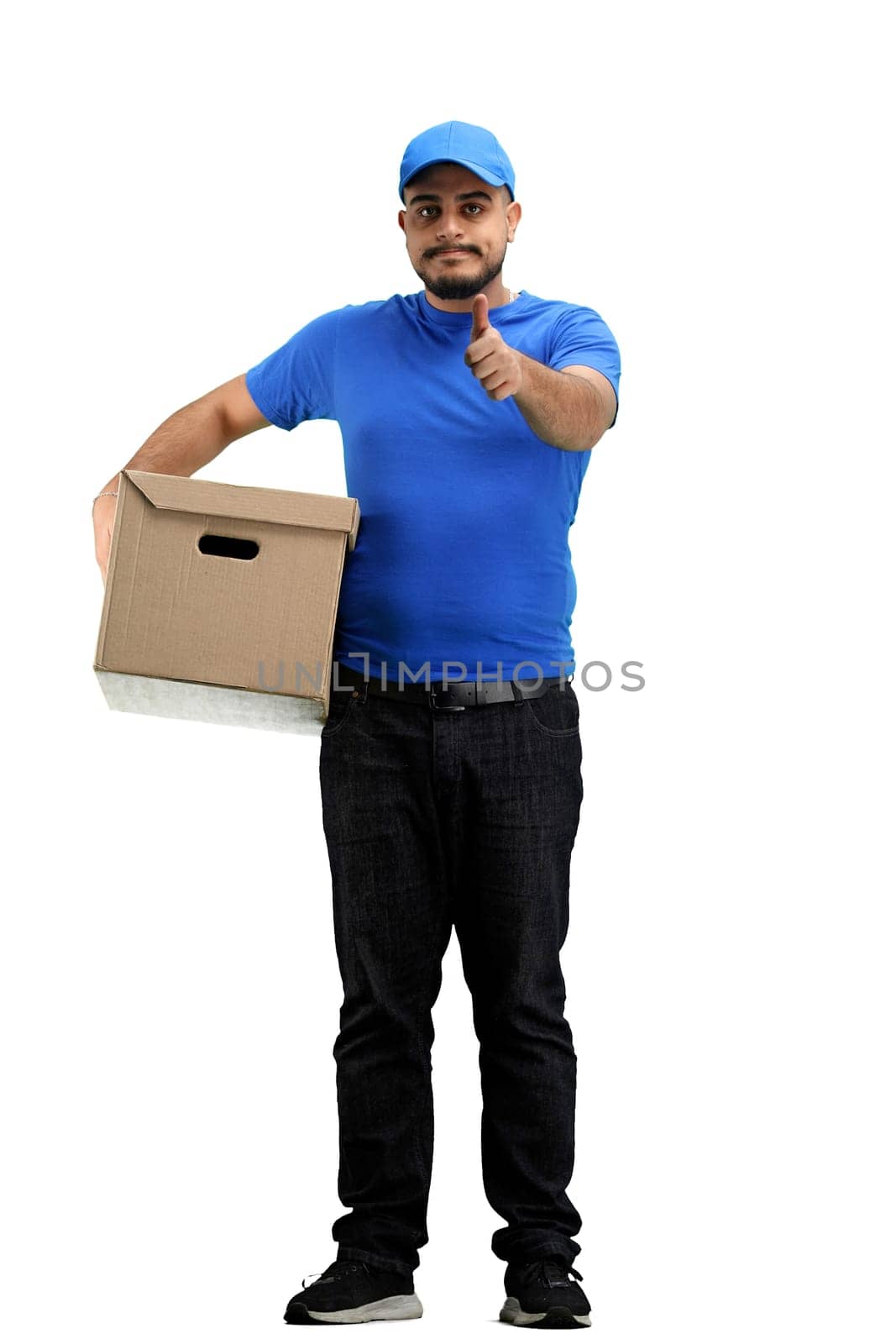 The deliveryman, in full height, on a white background, with a box, shows a thumbs up.