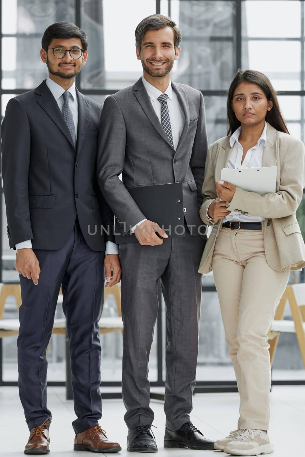 business people standing and looking straight ahead in a modern office
