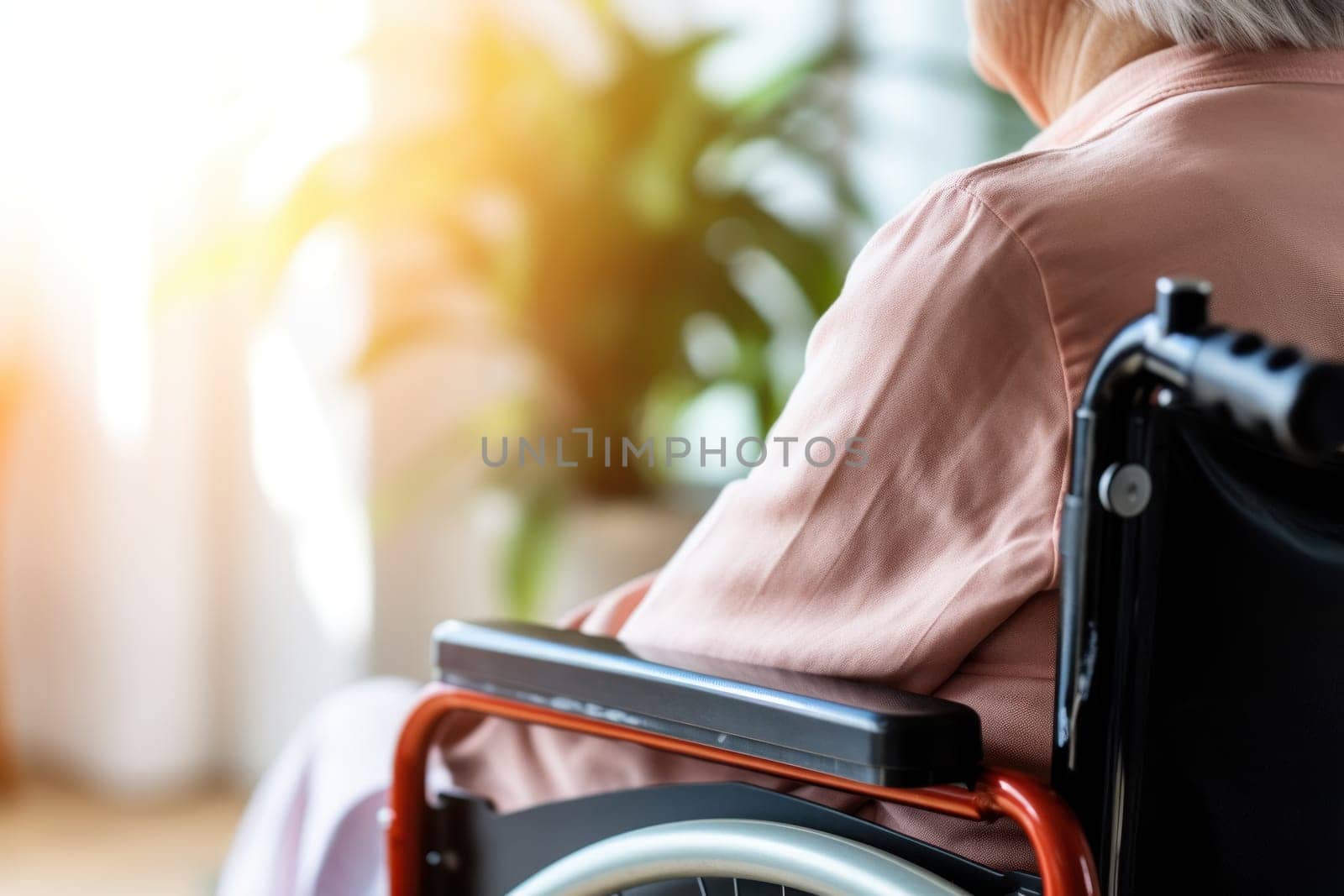 Rear view of an older patient sitting in wheelchair.