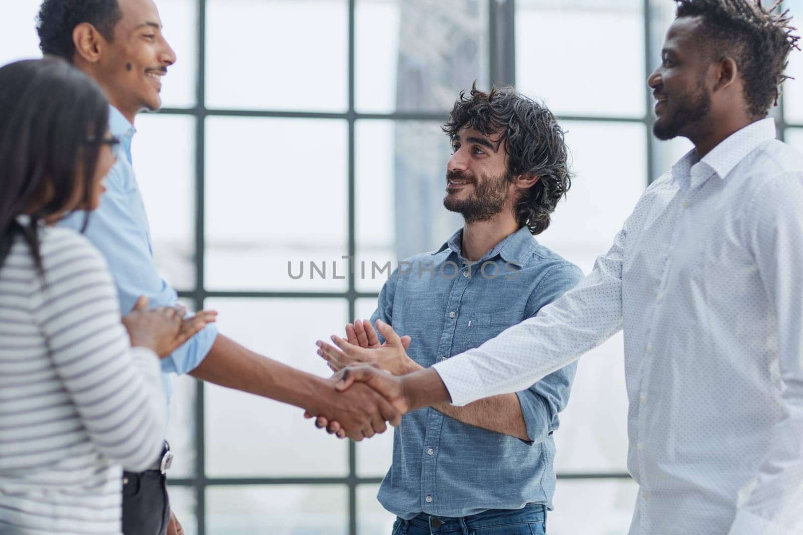 Successful Business Collaboration: Executives Greet with Handshake in Office by Prosto