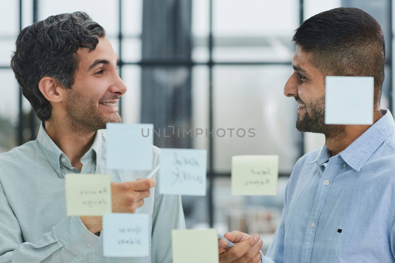 two successful businessmen in the office discuss a plan in office