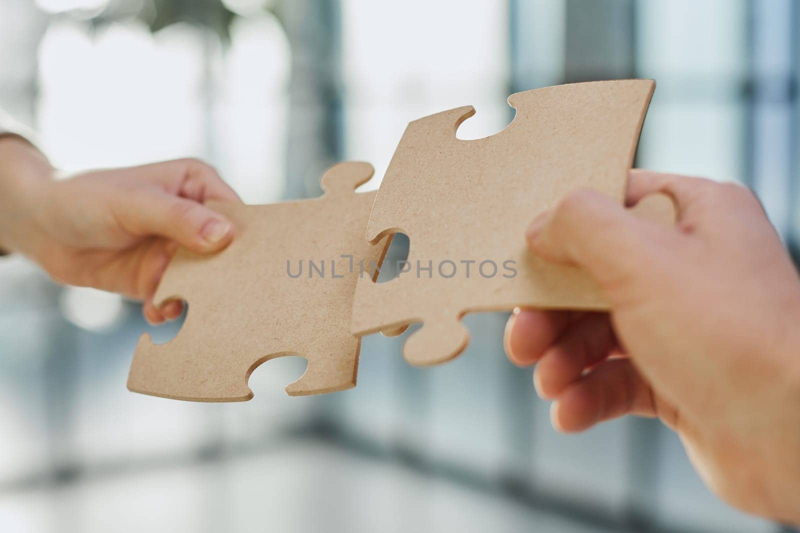 close up of business people connecting couple puzzle jigsaw, business solution concept. by Prosto