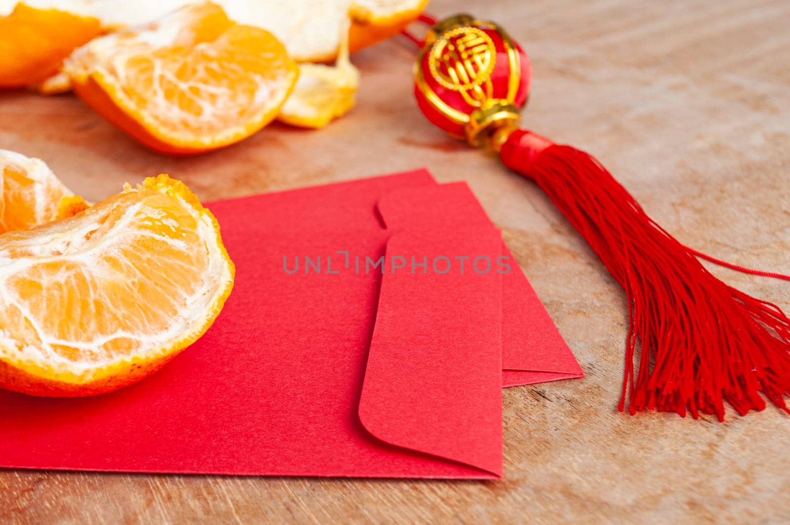 Peal Mandarin oranges and Chinese New Year red envelope. Chinese New Year celebration concept.