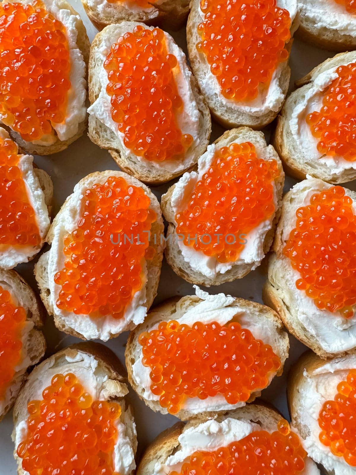 Baguette sandwiches with red salmon caviar and cheese. Top view. High quality photo