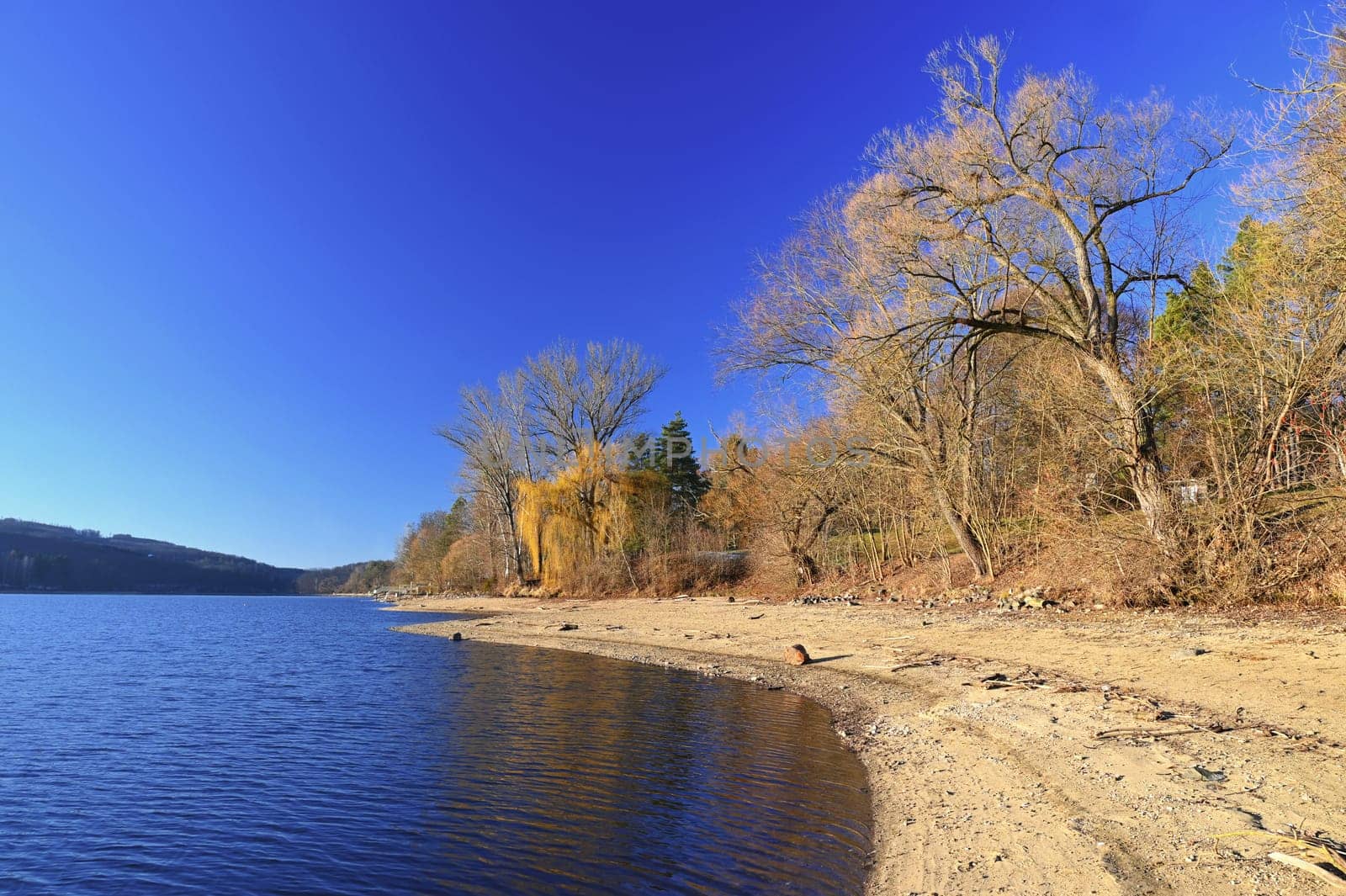 Brno Reservoir - City of Brno - Czech Republic - Europe. Beautiful landscape with water and beach. Nice sunny weather with blue sky in winter time.