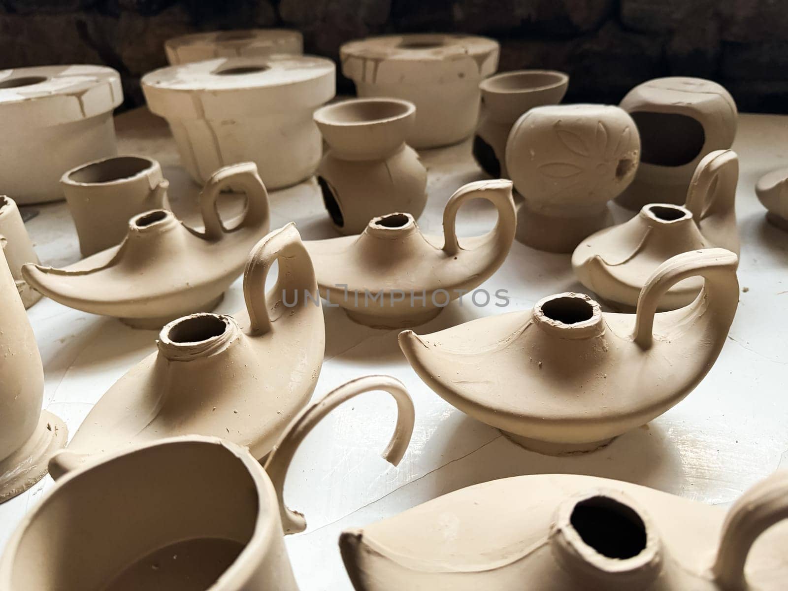 Clay blanks for a kerosene lamp in a pottery workshop. Close up photo. High quality photo