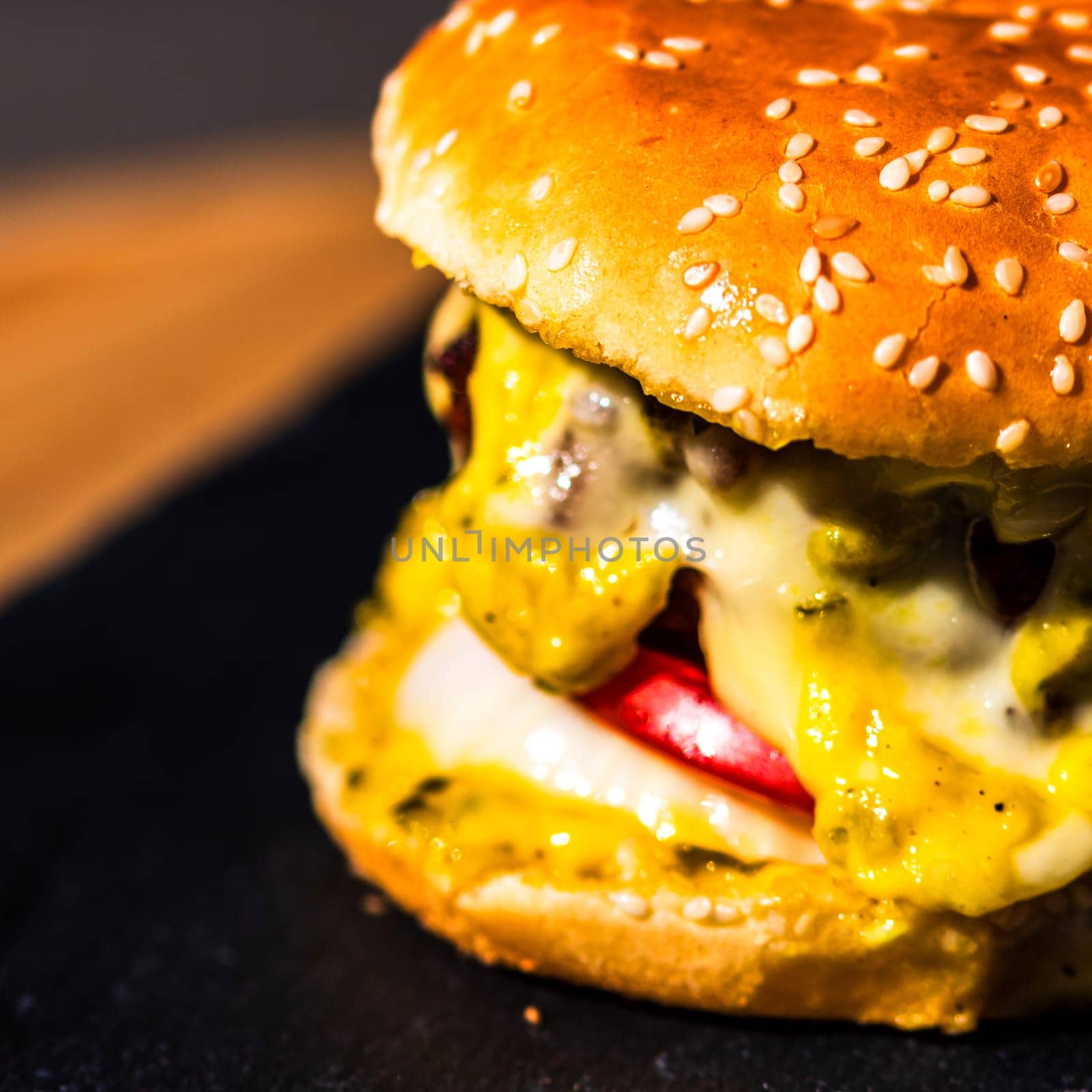 Tasty home made cheeseburger. Cheese burger with pickles, tomatoes, onion, melting cheese by vladispas