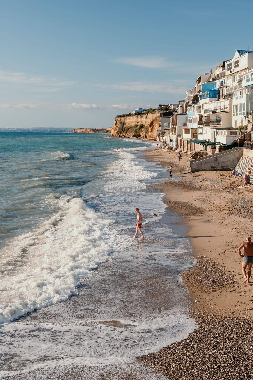 Coastal residential areas with a modern hotel and restaurant complex alongside sandy beaches. Summer holiday vacation and travel concept. by panophotograph