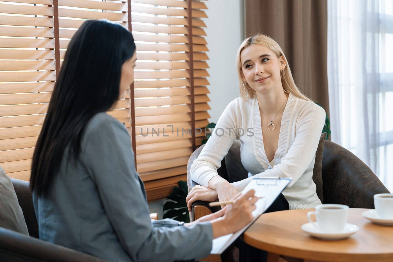Psychological consultation gaining improvement on mental problem, happy young female patient getting better during therapy session while psychiatrist making diagnostic on mental illness. Blithe