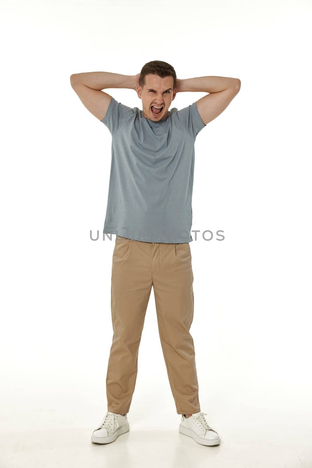 annoyed angry man shouting on white studio background