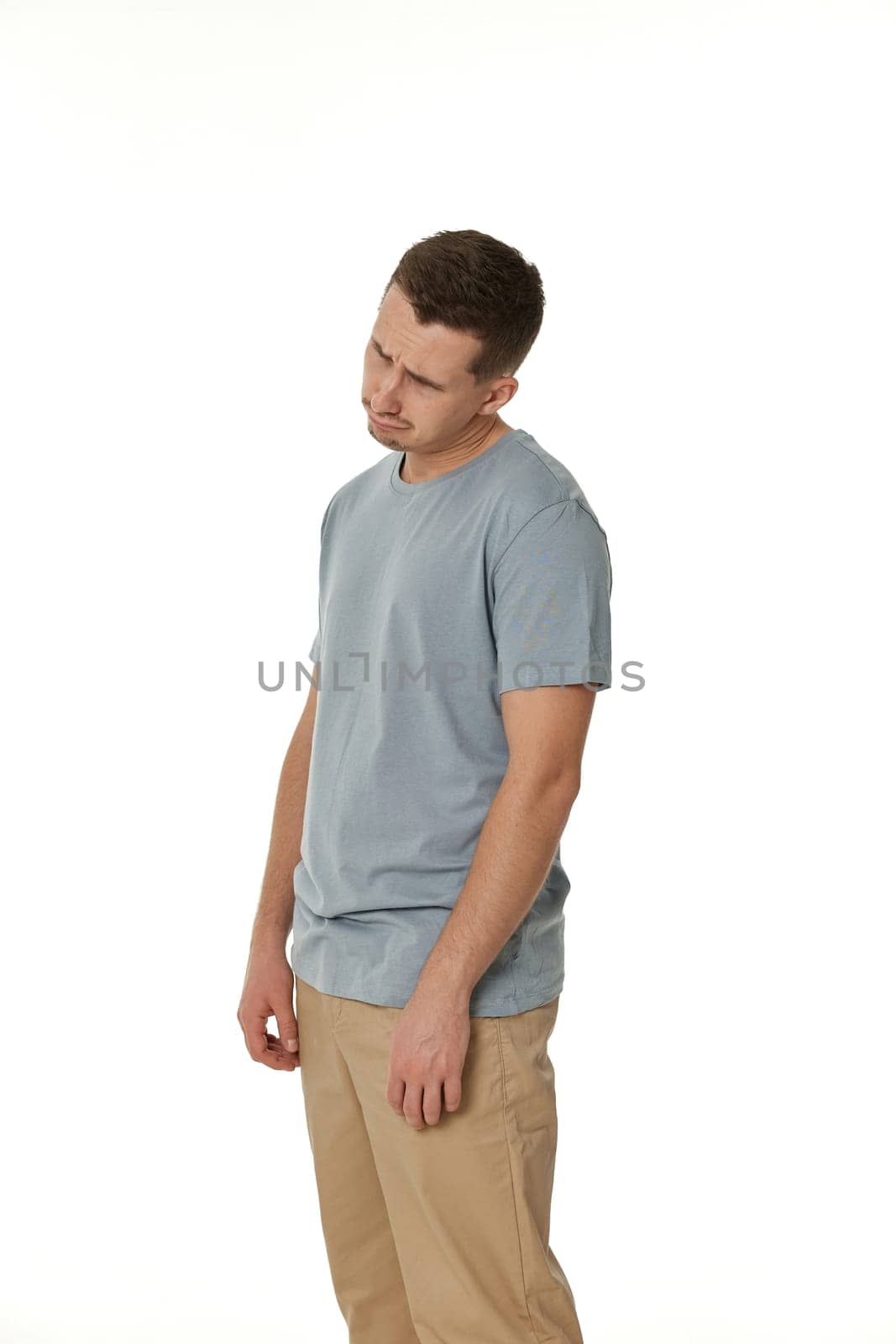 offended frustrated young man on white background. sadness