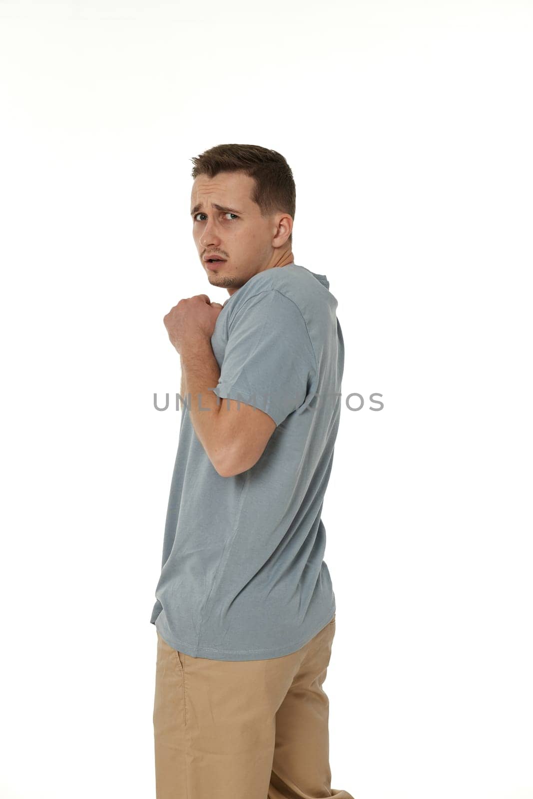 offended frustrated young man on white background. sadness