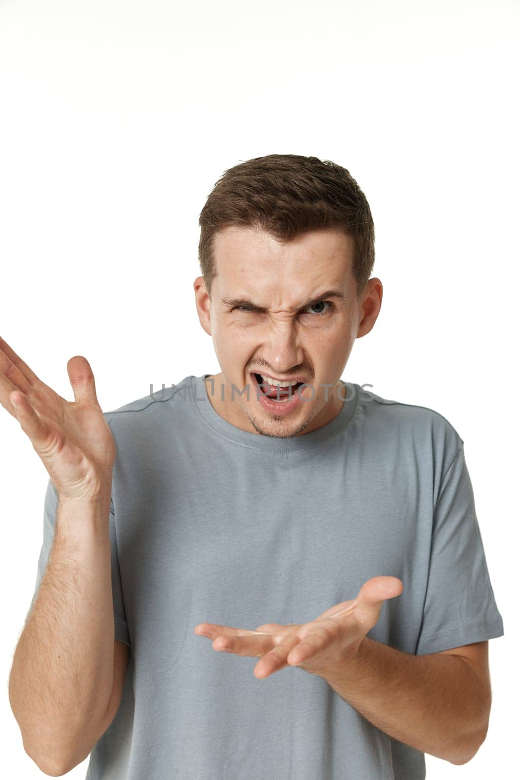 annoyed angry man shouting on white studio background