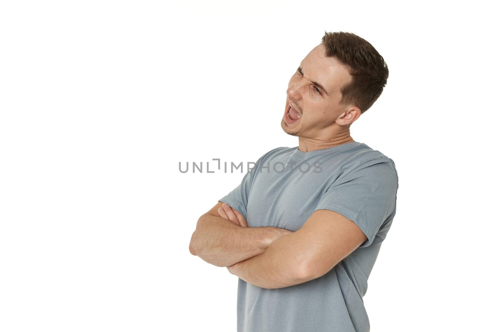 portrait of young happy man winking looking at the camera on white background