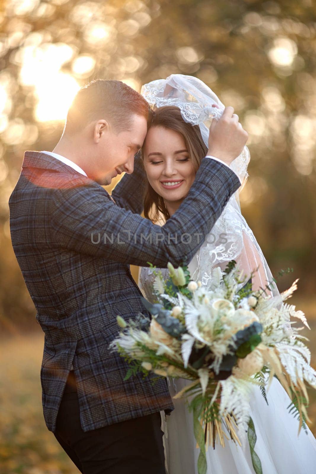 bride in white wedding dress and groom outdoor by erstudio