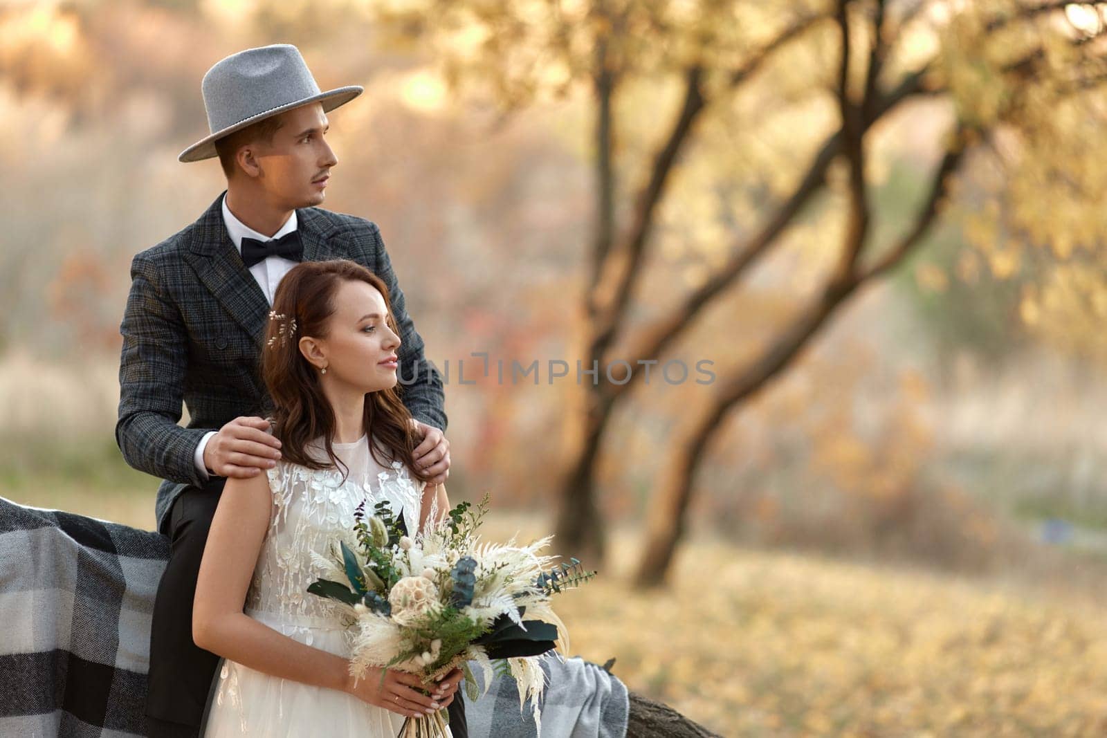 beautiful happy stylish bride and groom outdoor by erstudio