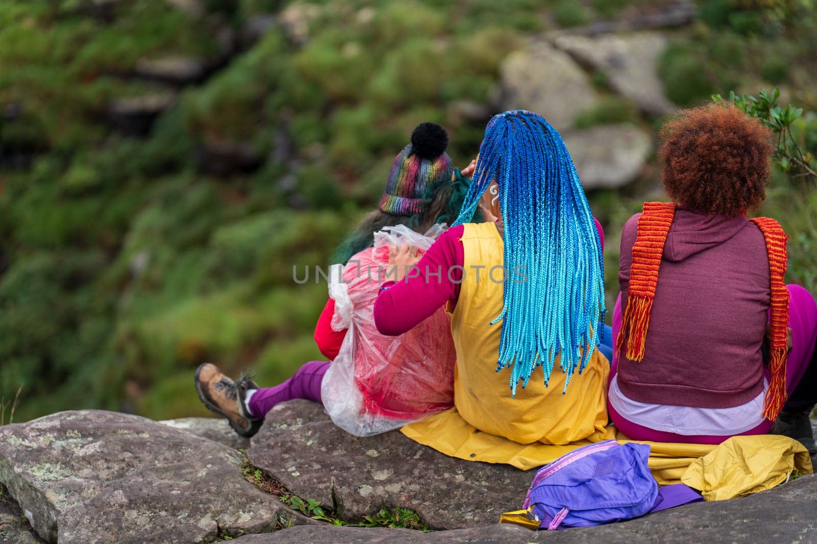 Trio of hikers resting in nature.